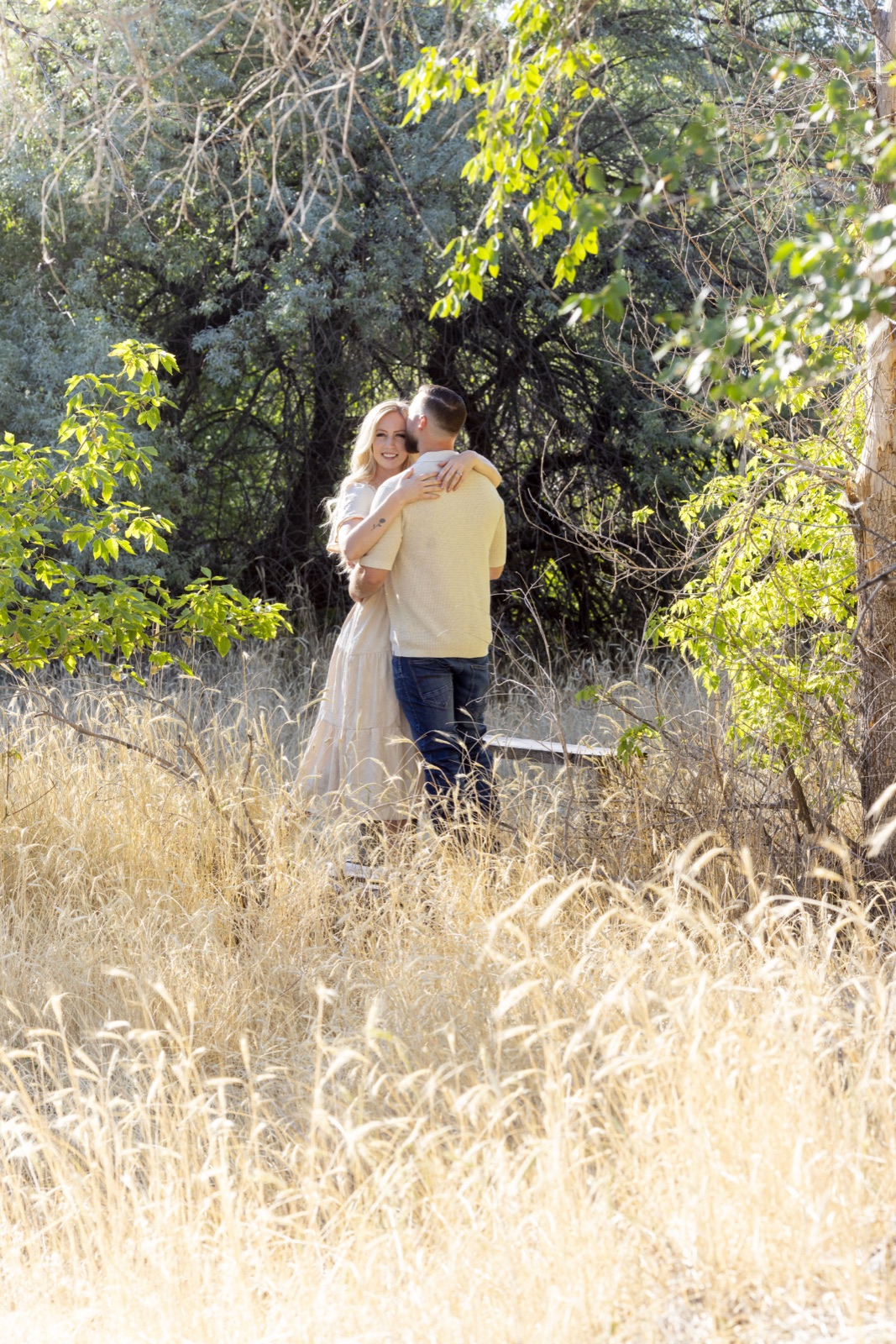 Trent and Steph in a field of golden grass